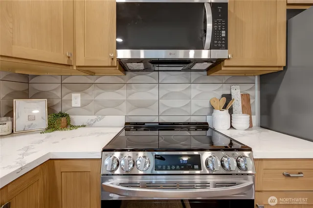 a stove top oven sitting inside of a kitchen
