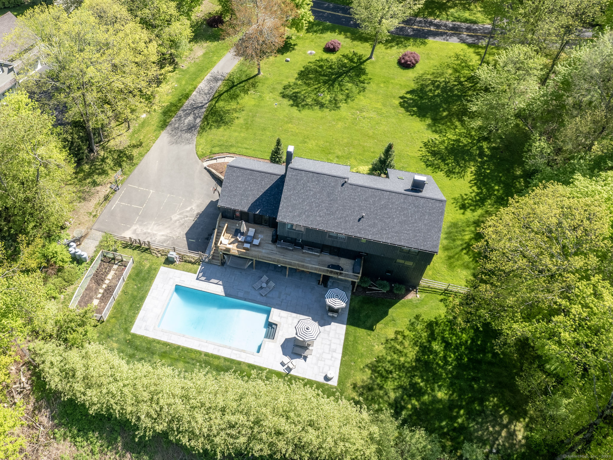 an aerial view of a house with garden space and street view
