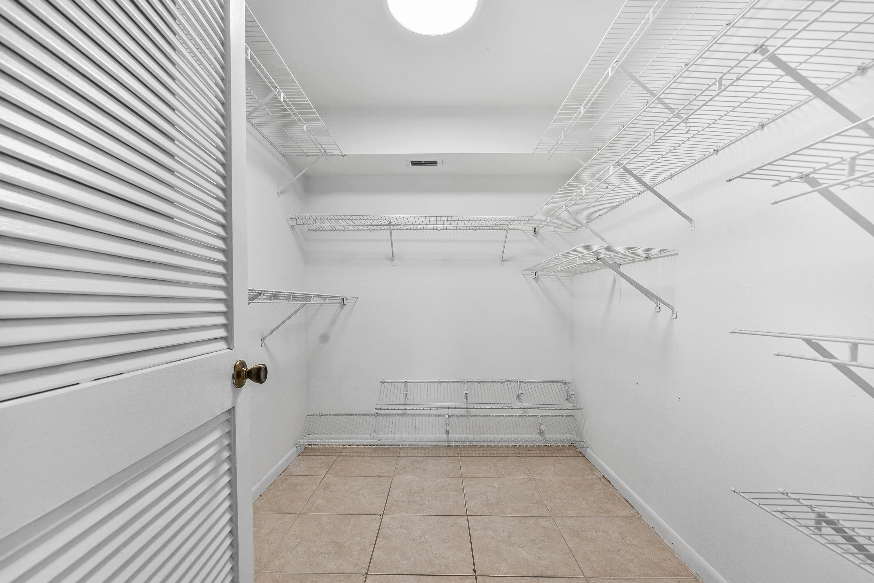 22725 Southwest 66th Avenue, Unit 103 Boca Raton, FL 33428 - Photo 12 of 14 Walk-In Closet – Ample Storage