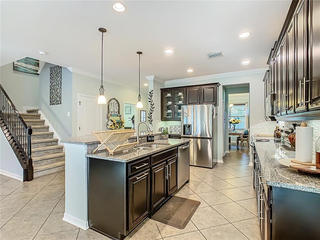 168 Magneta Loop Auburndale, FL 33823 - Photo 11 of 75 a kitchen with stainless steel appliances granite countertop a stove a sink and a refrigerator