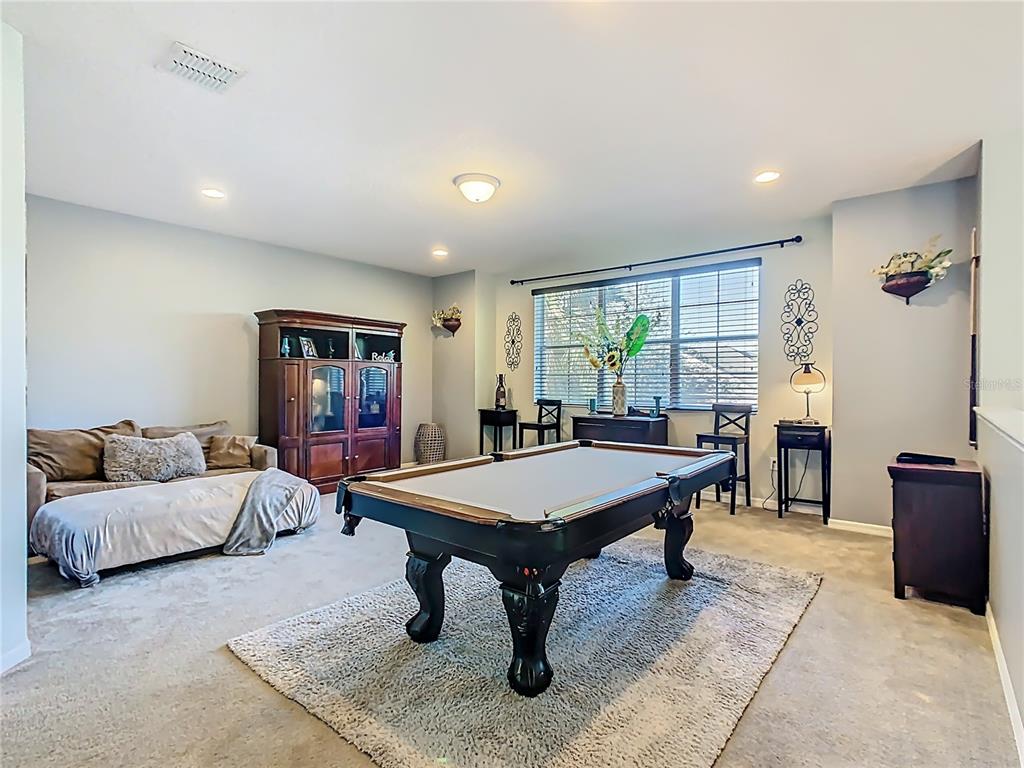 168 Magneta Loop Auburndale, FL 33823 - Photo 25 of 75 a living room with furniture a table and a flat screen tv