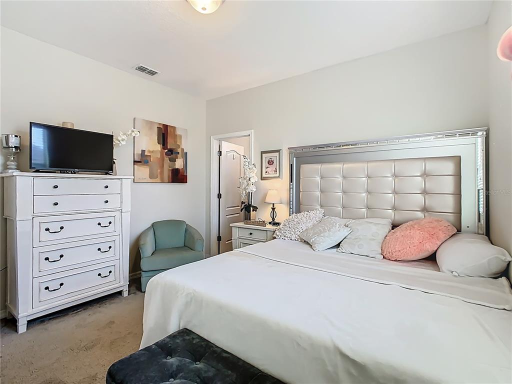 168 Magneta Loop Auburndale, FL 33823 - Photo 27 of 75 a bedroom with a bed a flat screen tv and dresser