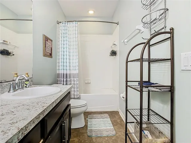 a bedroom with a bed and ceiling fan