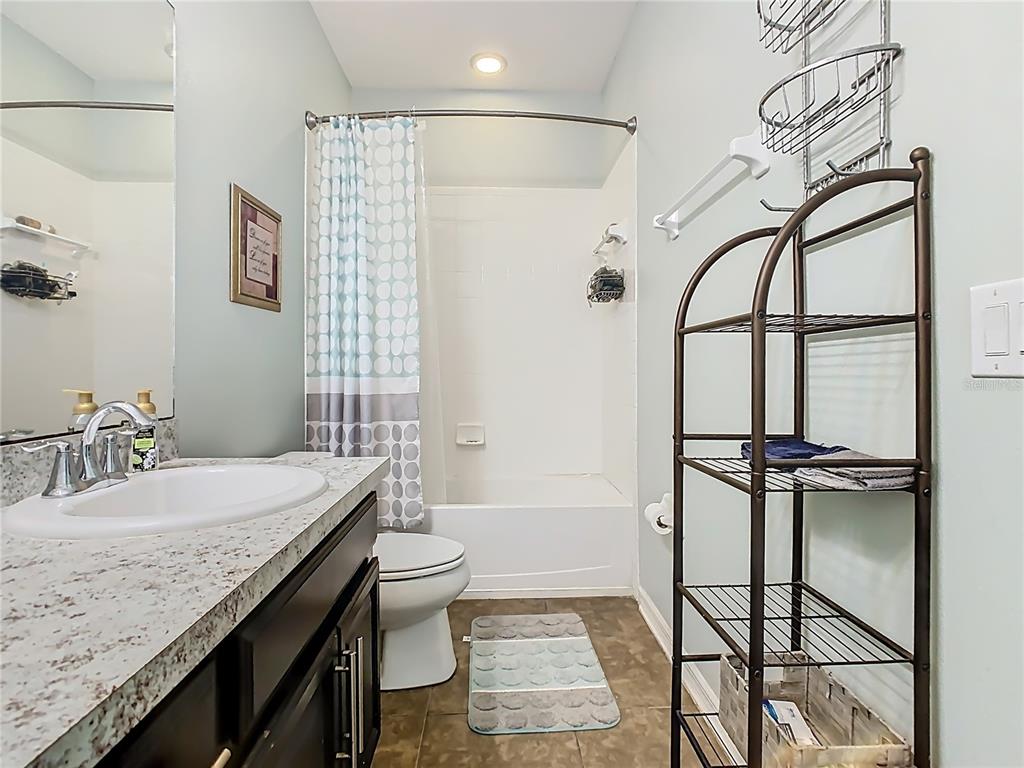 168 Magneta Loop Auburndale, FL 33823 - Photo 29 of 75 a bathroom with a granite countertop sink a mirror and a shower