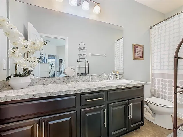 a bedroom with two beds and a flat screen tv