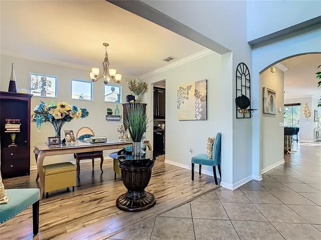 a living room with furniture a window and a potted plant