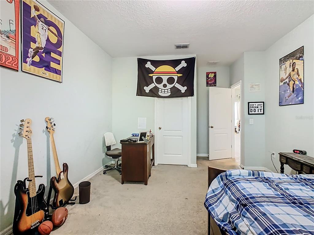 168 Magneta Loop Auburndale, FL 33823 - Photo 32 of 75 a bedroom with a bed and furniture