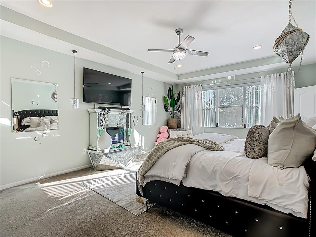 168 Magneta Loop Auburndale, FL 33823 - Photo 37 of 75 a bedroom with a bed a flat screen tv and a couch