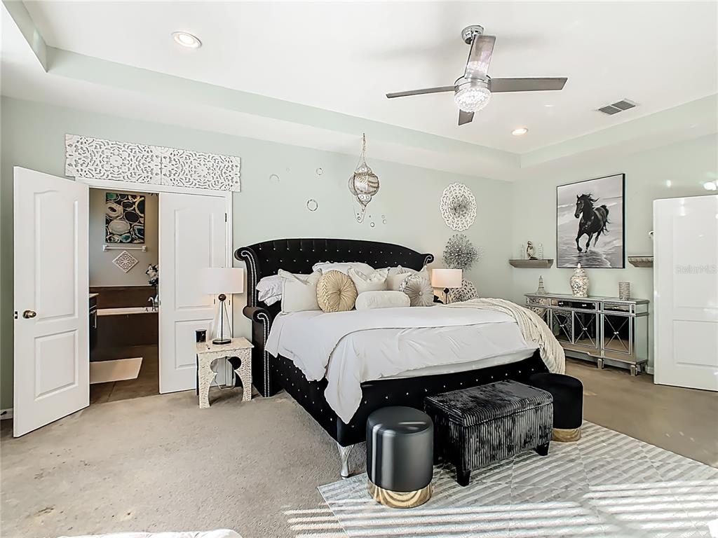 168 Magneta Loop Auburndale, FL 33823 - Photo 39 of 75 a bedroom with a bed and ceiling fan