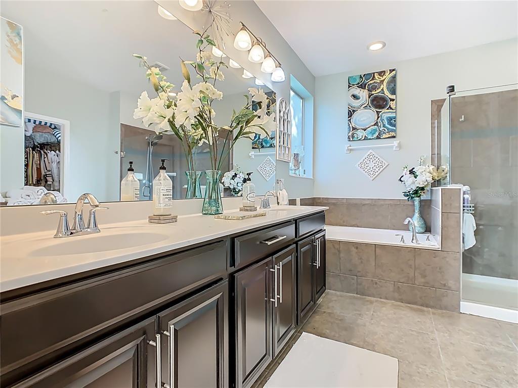 168 Magneta Loop Auburndale, FL 33823 - Photo 42 of 75 a bathroom with a granite countertop sink a large mirror and a bathtub