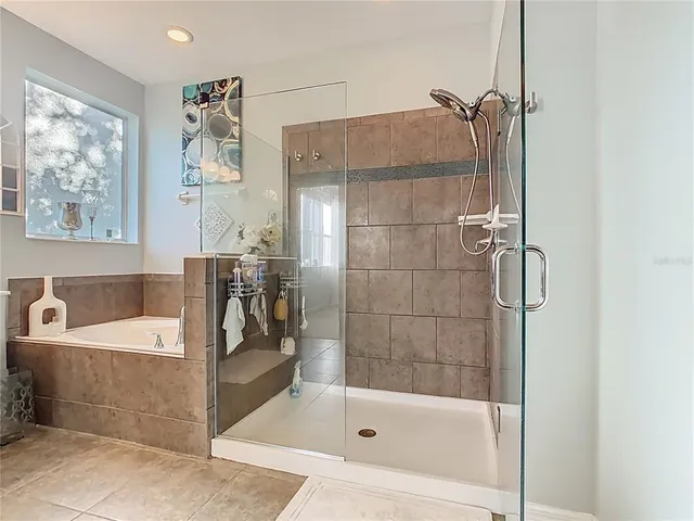 an aerial view of residential houses with outdoor space and parking