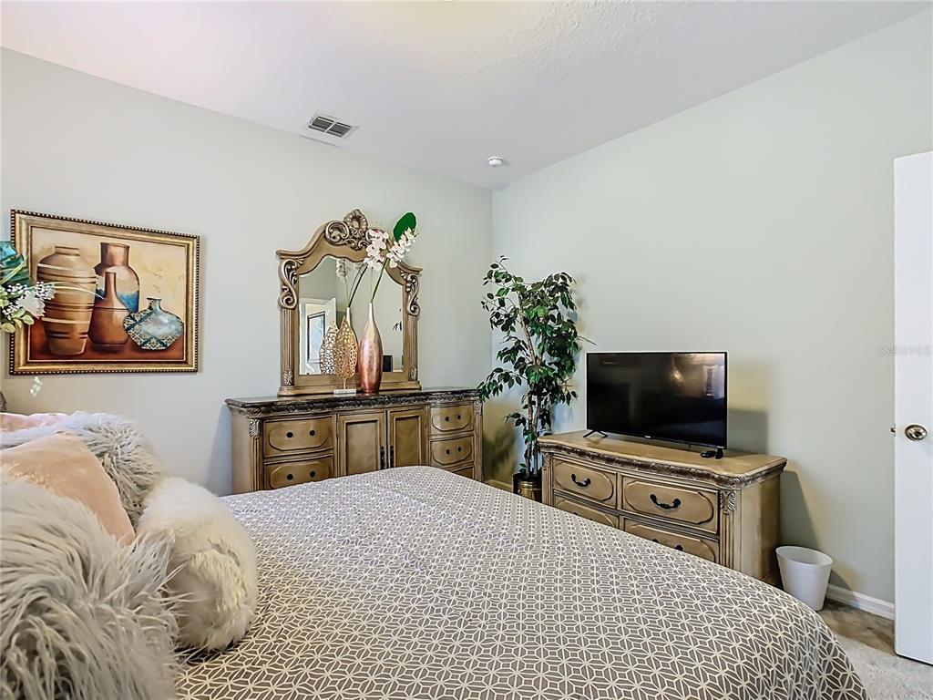 168 Magneta Loop Auburndale, FL 33823 - Photo 46 of 75 a bedroom with a bed and a flat screen tv