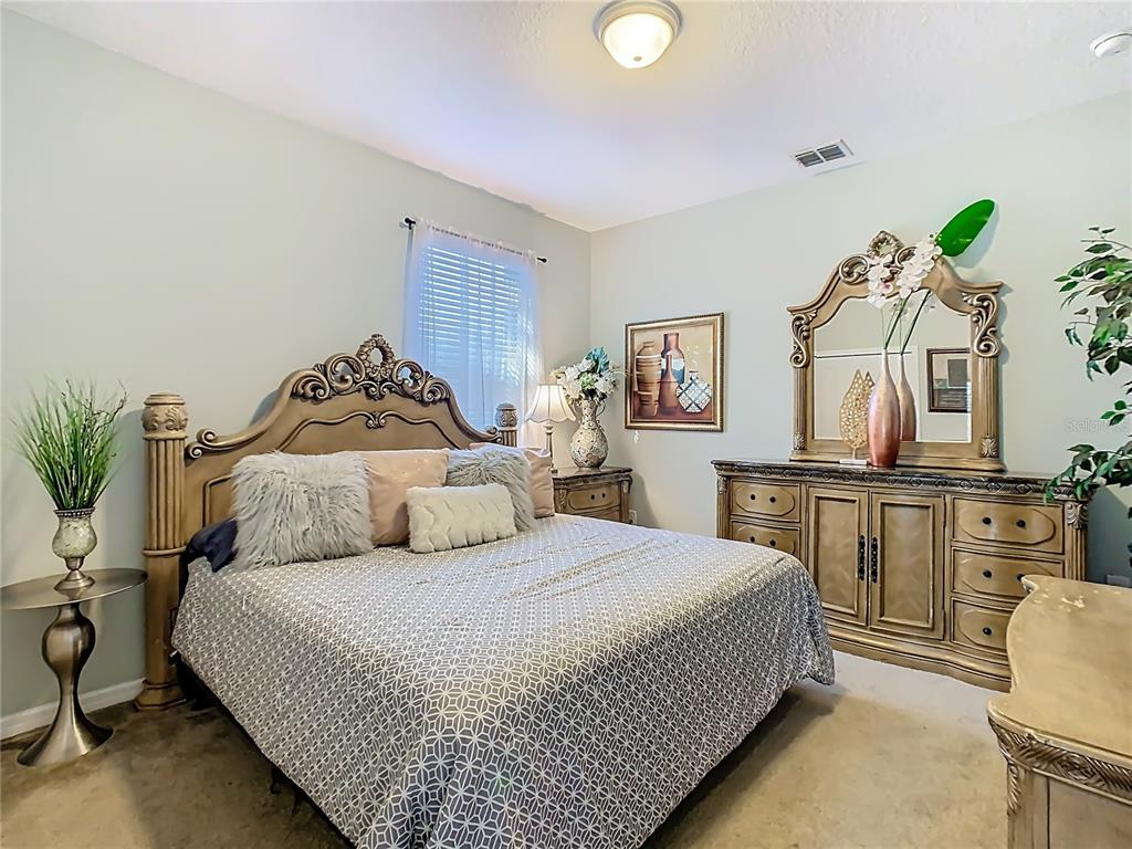 168 Magneta Loop Auburndale, FL 33823 - Photo 47 of 75 a bedroom with a bed and wooden floor