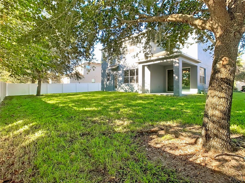 168 Magneta Loop Auburndale, FL 33823 - Photo 57 of 75 a front view of a house with yard and trees