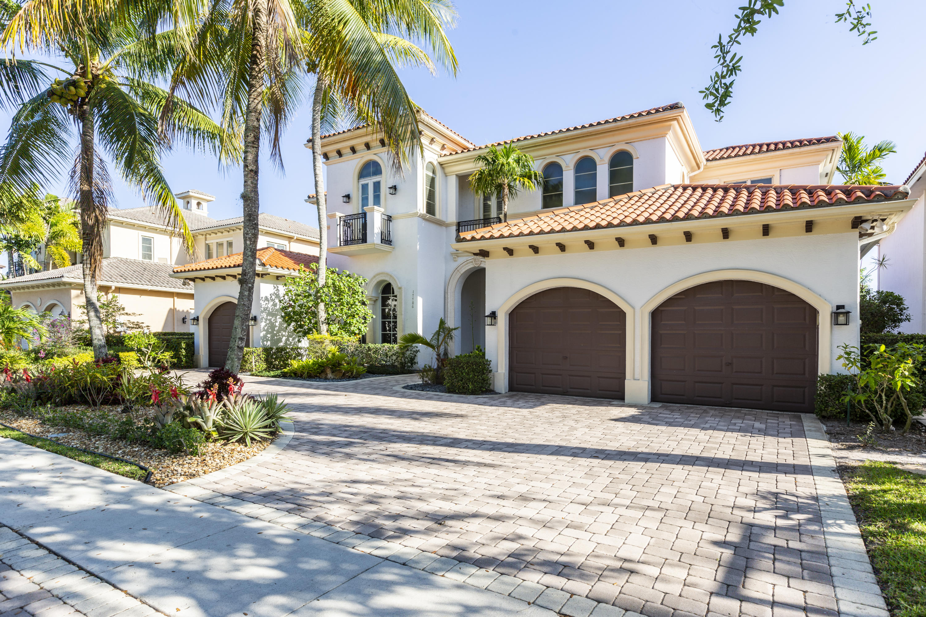 17706 Middlebrook Way Boca Raton, FL 33496 - Photo 3 of 61 a view of a white house with a yard and palm trees