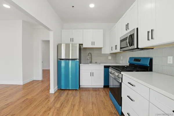 a kitchen with stainless steel appliances a refrigerator stove and sink