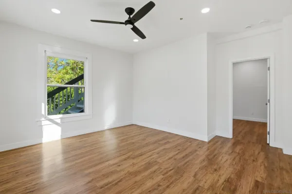 wooden floor in an empty room with a window