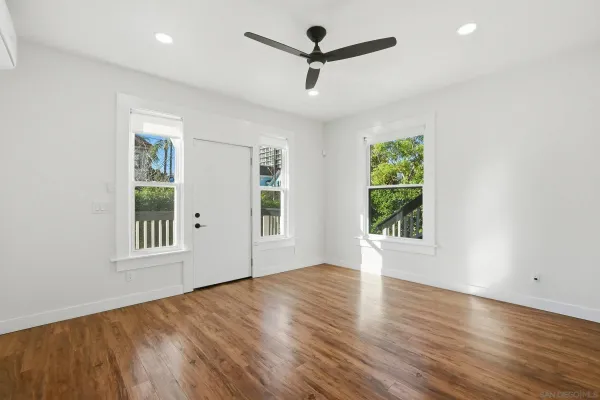 wooden floor in an empty room with a window