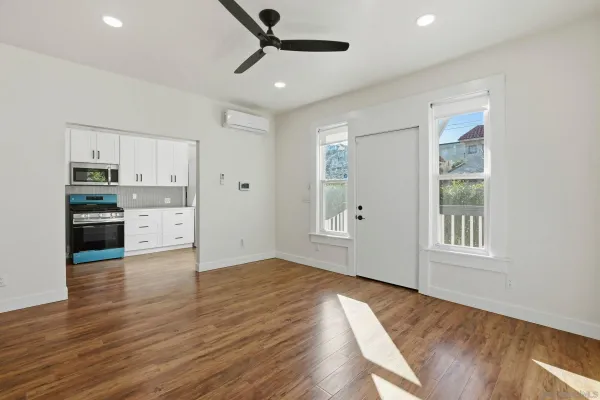 a view of a kitchen with microwave and stove top oven