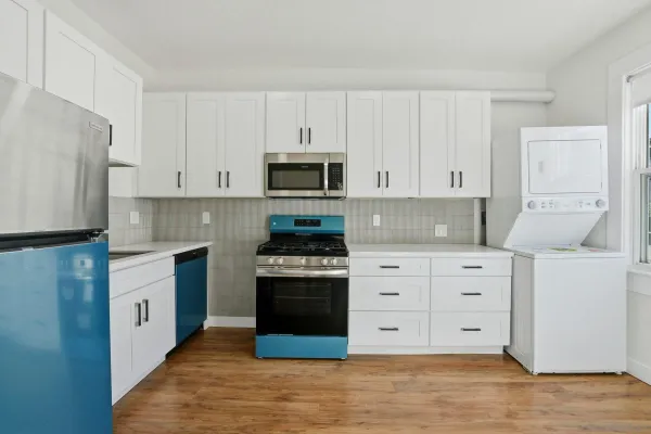 a kitchen with stainless steel appliances granite countertop a stove and a refrigerator