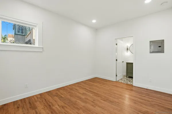 a view of empty room with wooden floor