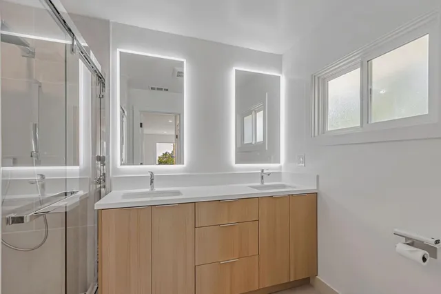 a bathroom with a granite countertop sink mirror and a bathtub