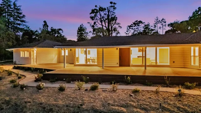 a view of a swimming pool with outdoor seating