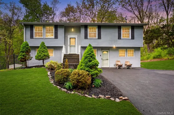 a front view of a house with a garden