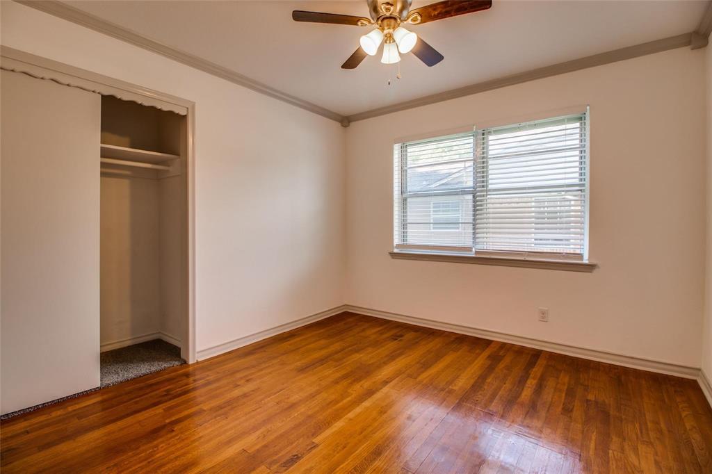 702 Ridgedale Drive Garland, TX 75041 - Photo 12 of 23 a view of an empty room with wooden floor and a window