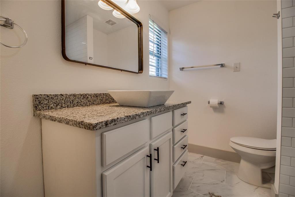 702 Ridgedale Drive Garland, TX 75041 - Photo 15 of 23 a bathroom with a granite countertop sink and a toilet