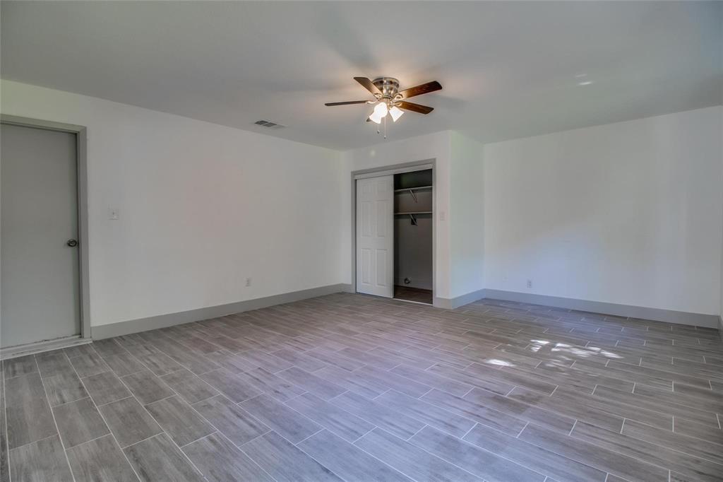 702 Ridgedale Drive Garland, TX 75041 - Photo 18 of 23 a view of an empty room with wooden floor
