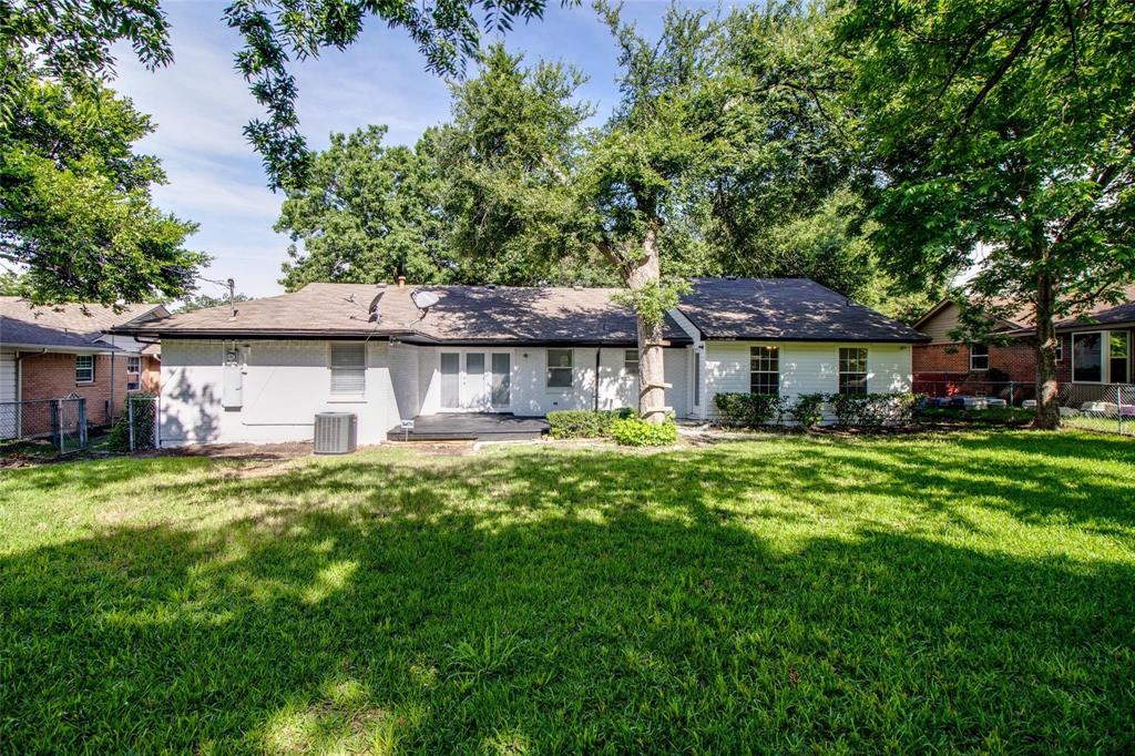 702 Ridgedale Drive Garland, TX 75041 - Photo 22 of 23 a front view of a house with a garden