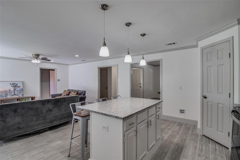 702 Ridgedale Drive Garland, TX 75041 - Photo 23 of 23 a view of kitchen island with furniture and wooden floor