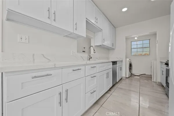 a kitchen with cabinets and window