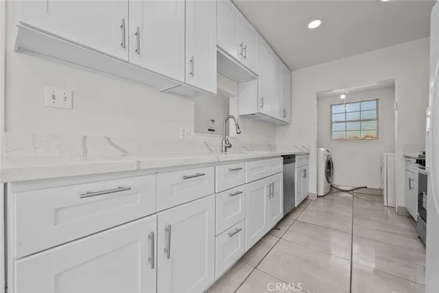 a kitchen with cabinets and window