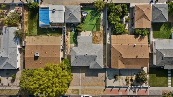 an aerial view of multiple houses with a yard
