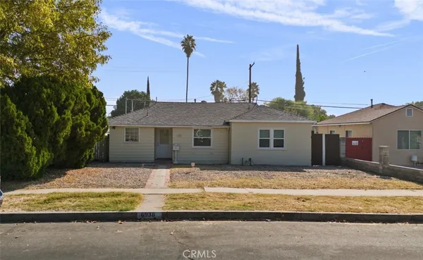 a house that has a tree in front of it