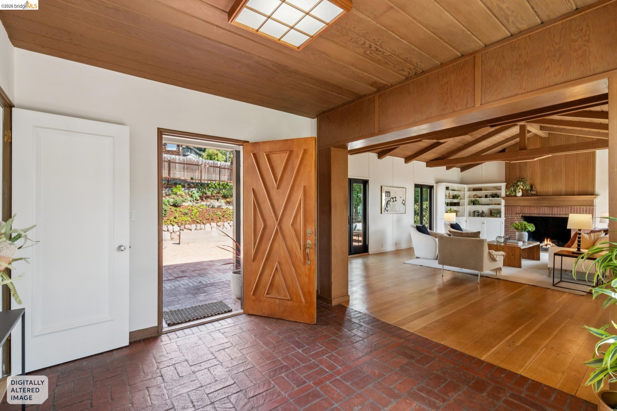 Brick flooring entryway with a geometric-paneled wood door