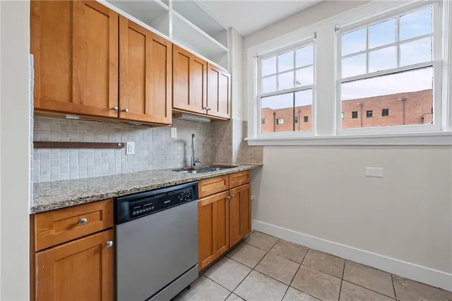 a kitchen with stainless steel appliances granite countertop a sink and a stove