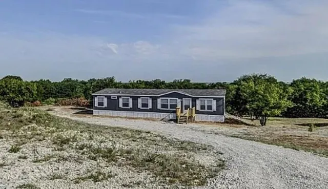 a house with trees in the background