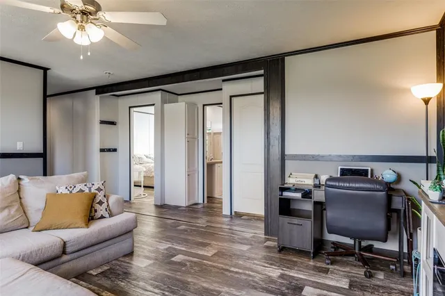 a living room with furniture and a ceiling fan