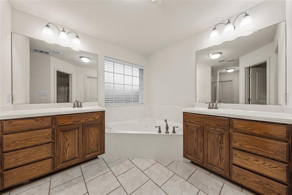 109 Ruby Circle Hewitt, TX 76643 - Photo 9 of 14 a spacious bathroom with a granite countertop double vanity sink mirror and bathtub