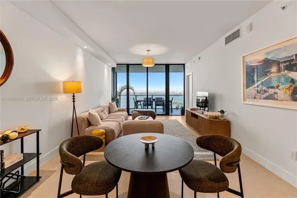 a living room with furniture and a large window