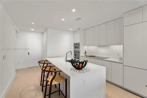 a kitchen with a table chairs stove and cabinets