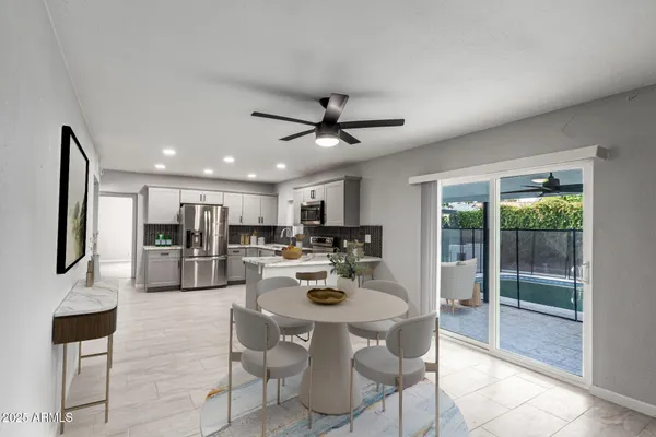 a dining room with kitchen island furniture a chandelier and a view of kitchen