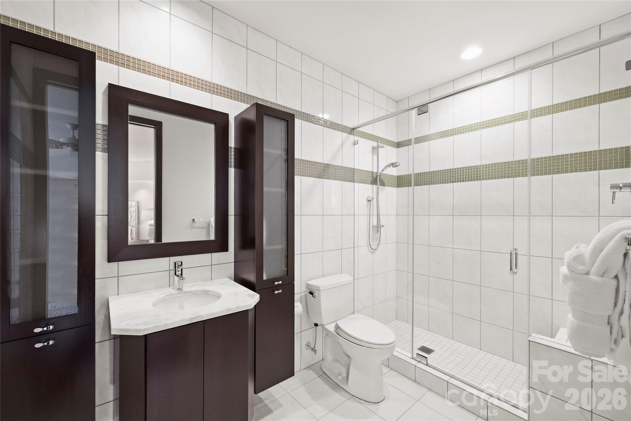 139 South Tryon Street, Unit 6 Charlotte, NC 28202 - Photo 38 of 47 a bathroom with a sink shower and a toilet