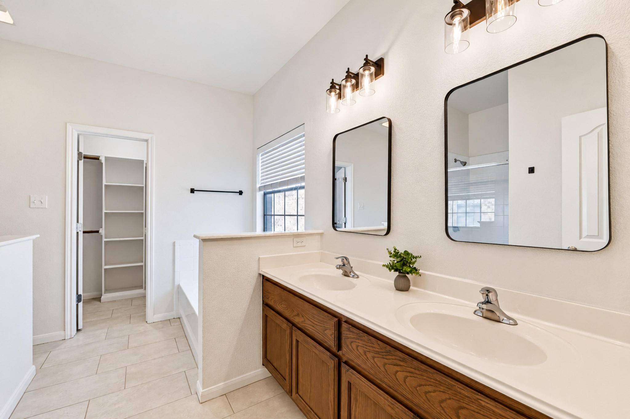 150 Engineers Pass Jarrell, TX 76537 - Photo 32 of 40 Clean lines and a spacious dual vanity highlight this bright primary bathroom layout.