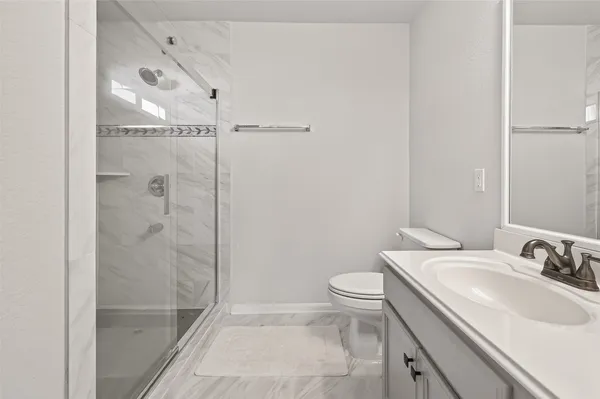 a bathroom with a sink toilet and shower