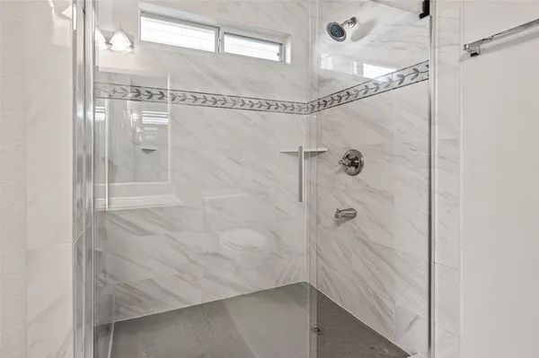a bathroom with a glass shower door
