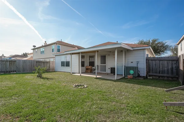 a view of a house with a yard and sitting area